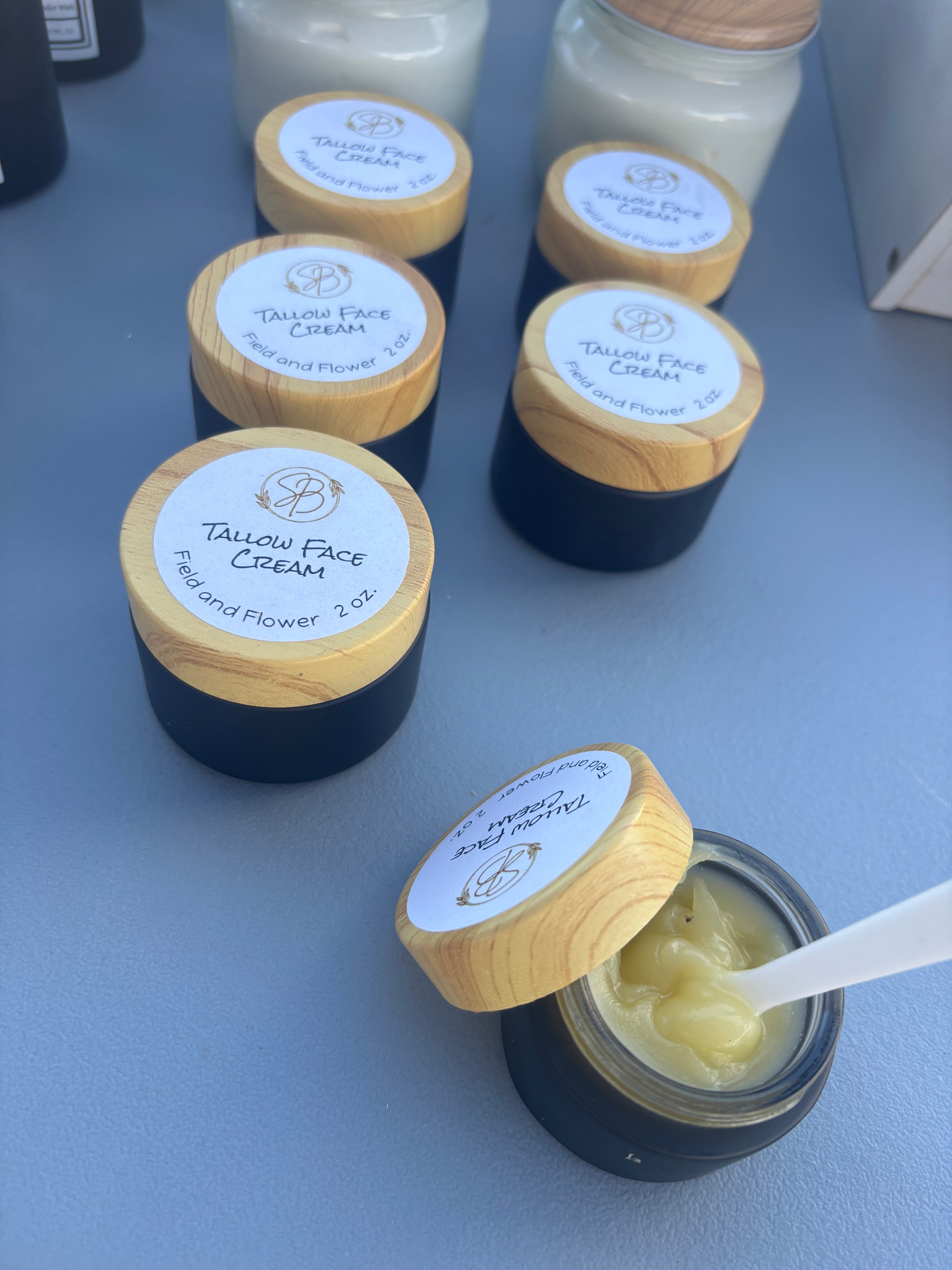 Jars of Taudry Face Cream on a gray surface
