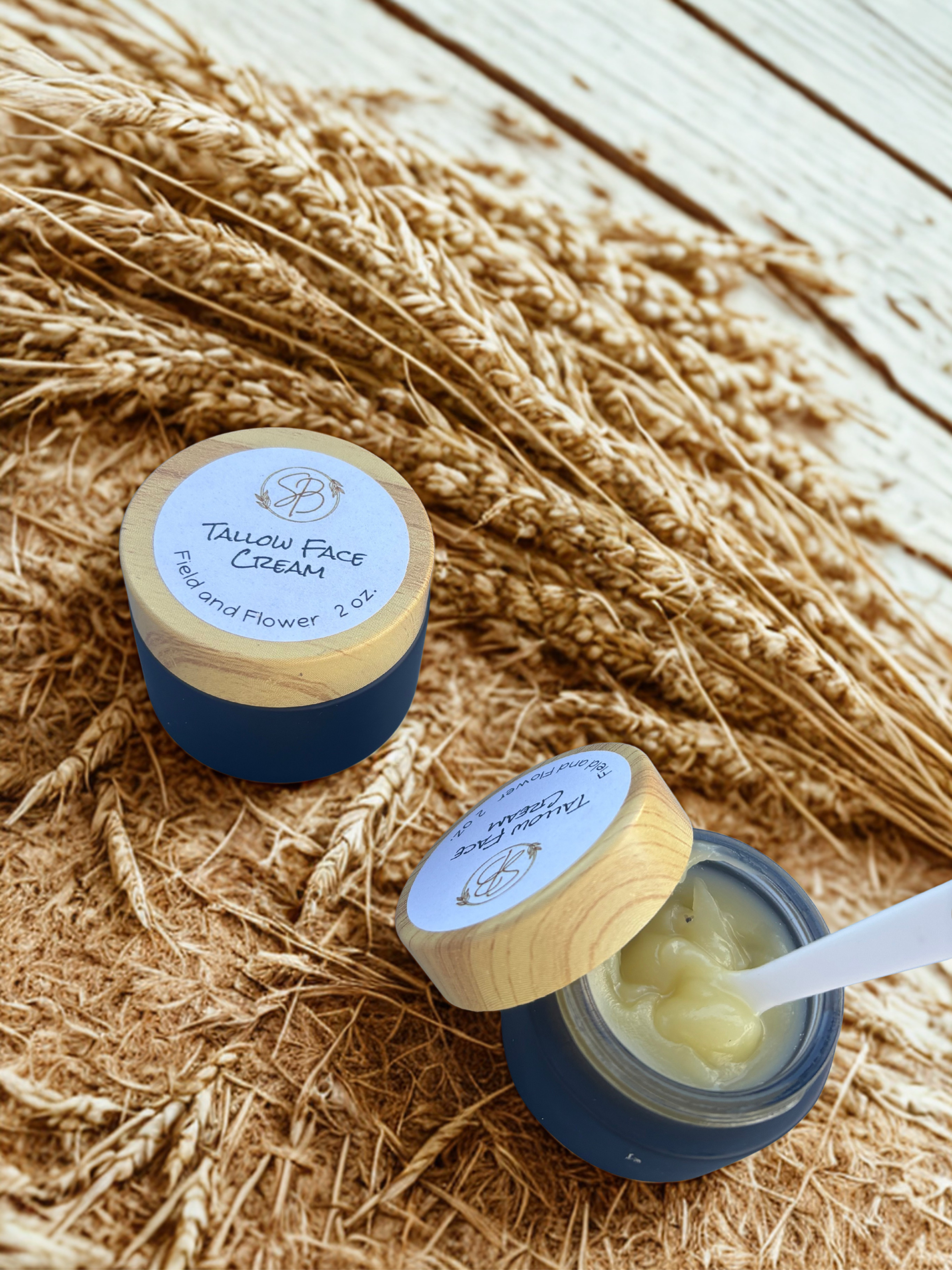 Two jars of Talcum Face Cream on a wooden surface with straw background