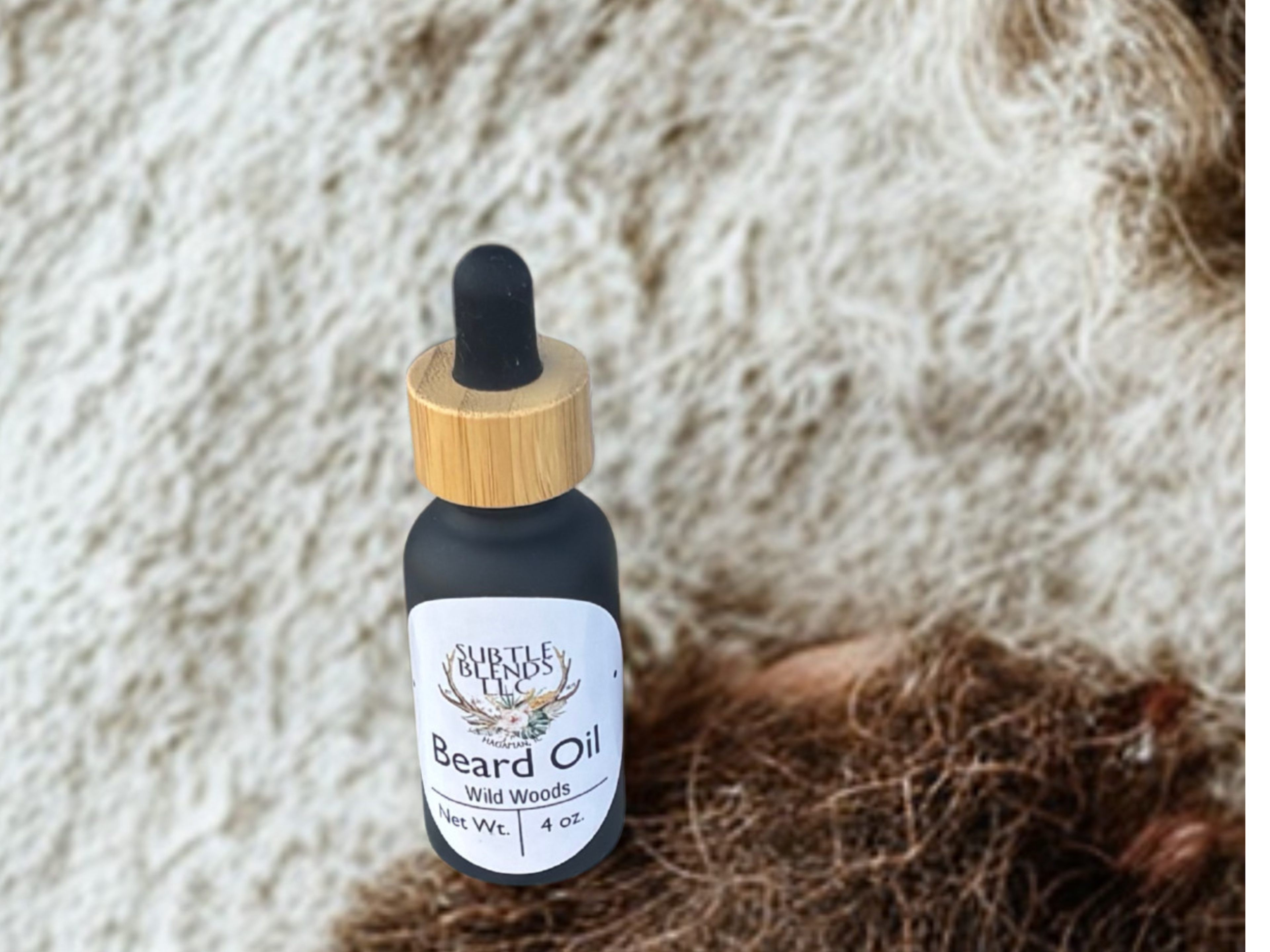 Bottle of 'Beard Oil' with a dropper on a textured beige background